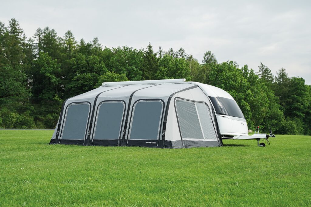 Wohnwagen mit Vorzelt auf grünem Feld